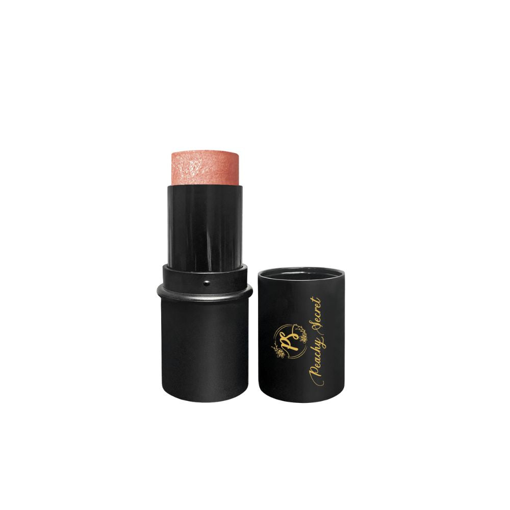 Botanical highlighter stick in coppery peach tone with black cap and tube