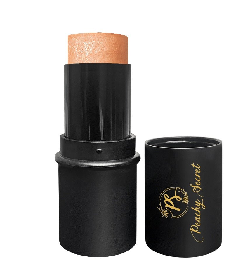 Botanical highlighter stick in peach-gold tone with black cap and tube