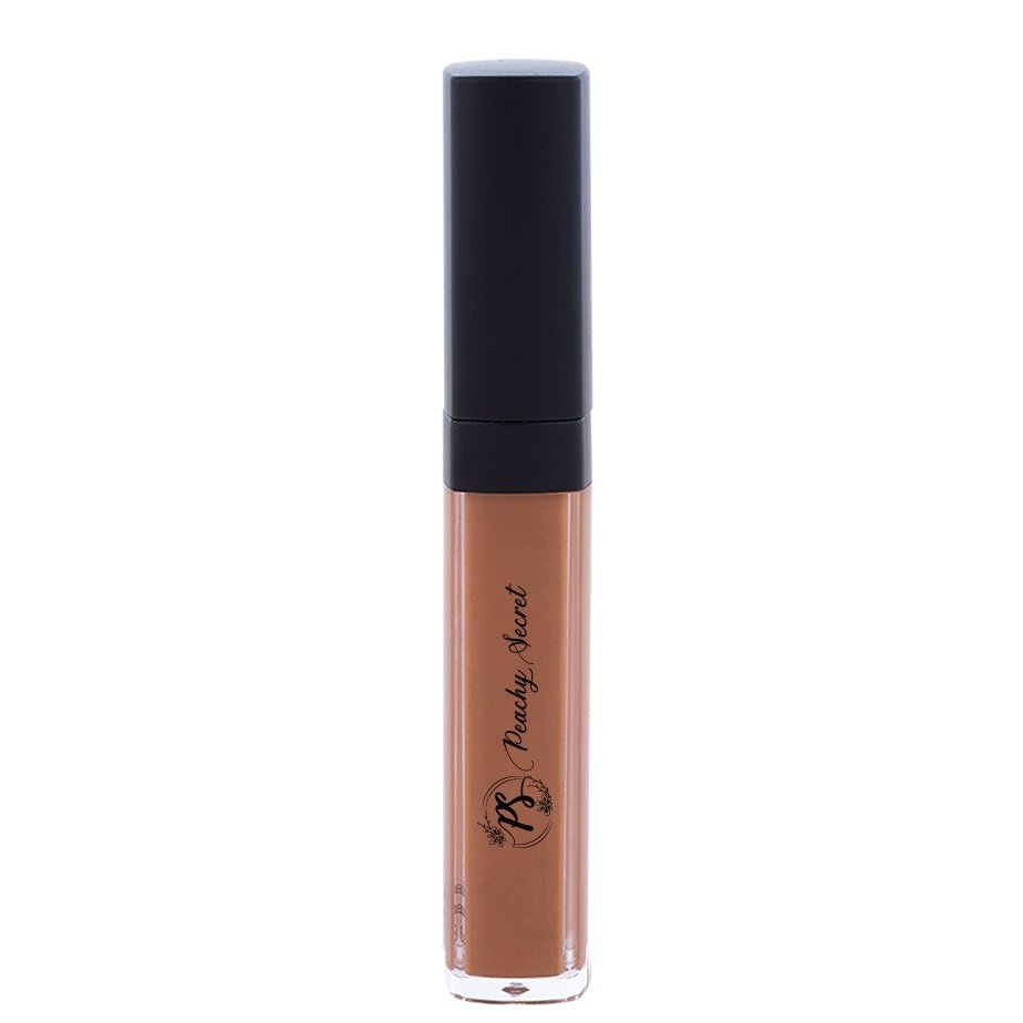 Liquid concealer in warm medium brown in clear tube with black cap