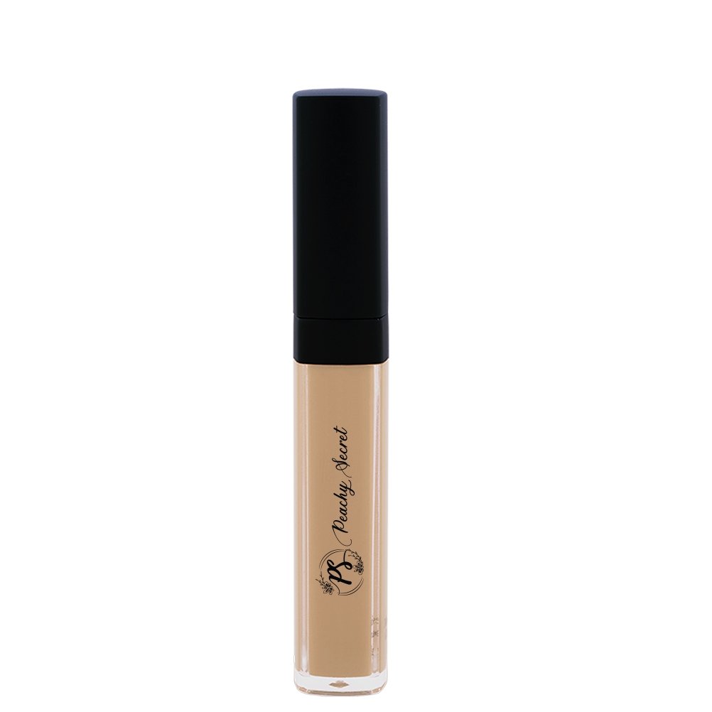 Liquid concealer in pale beige in clear tube with black cap