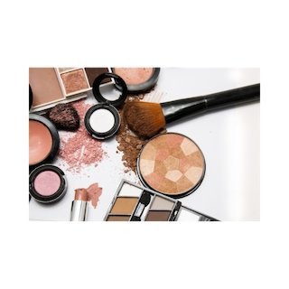 Makeup powders, brushes, and compacts on a vanity surface