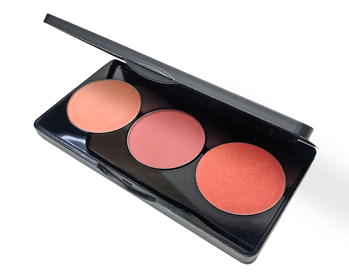 Blush makeup palette with three round pans in soft peach, coral pink, and warm rose