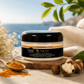 Turmeric shea butter jar with black cap on wooden surface