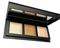 Open face highlighter palette showing three shimmer pans: cream, gold, and light beige.